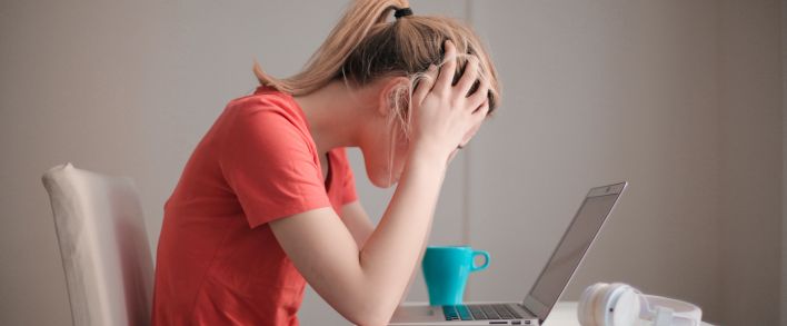 Woman in Red T-shirt Looking at Her Laptop